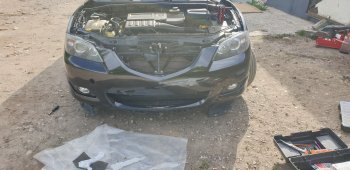 6 999 р. Передний бампер TYG (без отверстий под омыватели, 1.6L/2.0L) Mazda 3/Axela BK дорестайлинг седан (2003-2006) (Неокрашенный)  с доставкой в г. Пермь. Увеличить фотографию 2